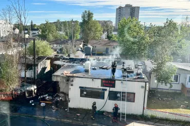 Firefighters work on the Wood Fired Pizzeria building following a June 18, 2026 fire. Photo: Leon Milner