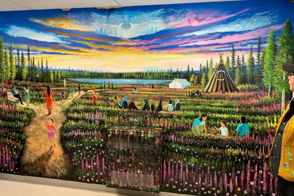 James Wedzin, right, and his mural. Dieselle Ford/Cabin Radio