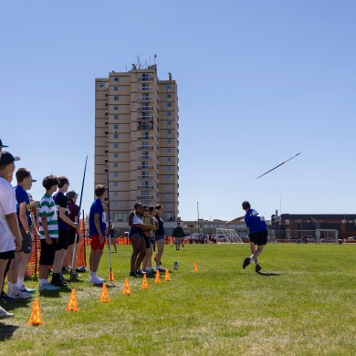 Ethan Strader begins the javelin at Track and Field 2026 with fellow contenders looking on. Ollie Williams/Cabin Radio