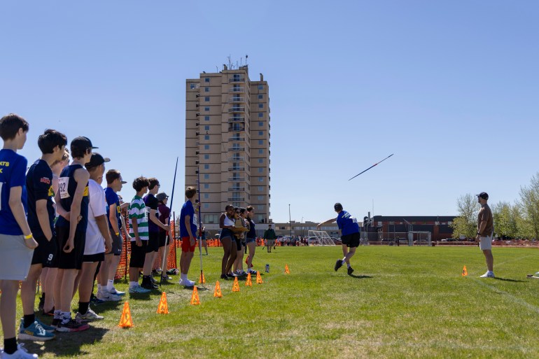 Ethan Strader begins the javelin at Track and Field 2026 with fellow contenders looking on. Ollie Williams/Cabin Radio