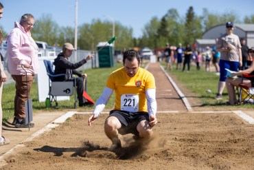 Ahmed Gargouri in an adult long jump contest at Track and Field 2026. Ollie Williams/Cabin Radio