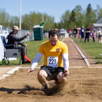 Ahmed Gargouri in an adult long jump contest at Track and Field 2026. Ollie Williams/Cabin Radio