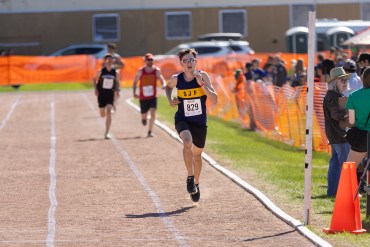 Logan Doll racing the 5,000m at Track and Field 2026. Ollie Williams/Cabin Radio