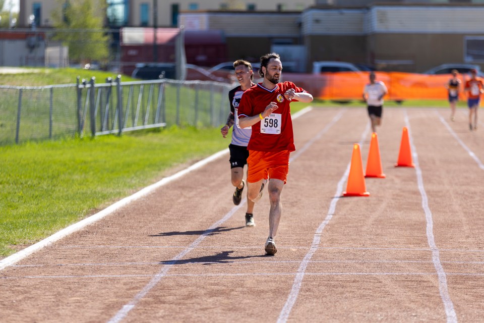 Keith Sulzer checks his time at the end of the men's 5,000m race at Track and Field 2026. Ollie Williams/Cabin Radio