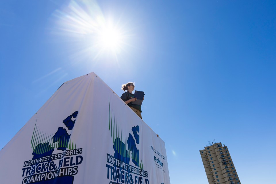 A race official surveys the scene at Track and Field 2026 in Hay River. Ollie Williams/Cabin Radio
