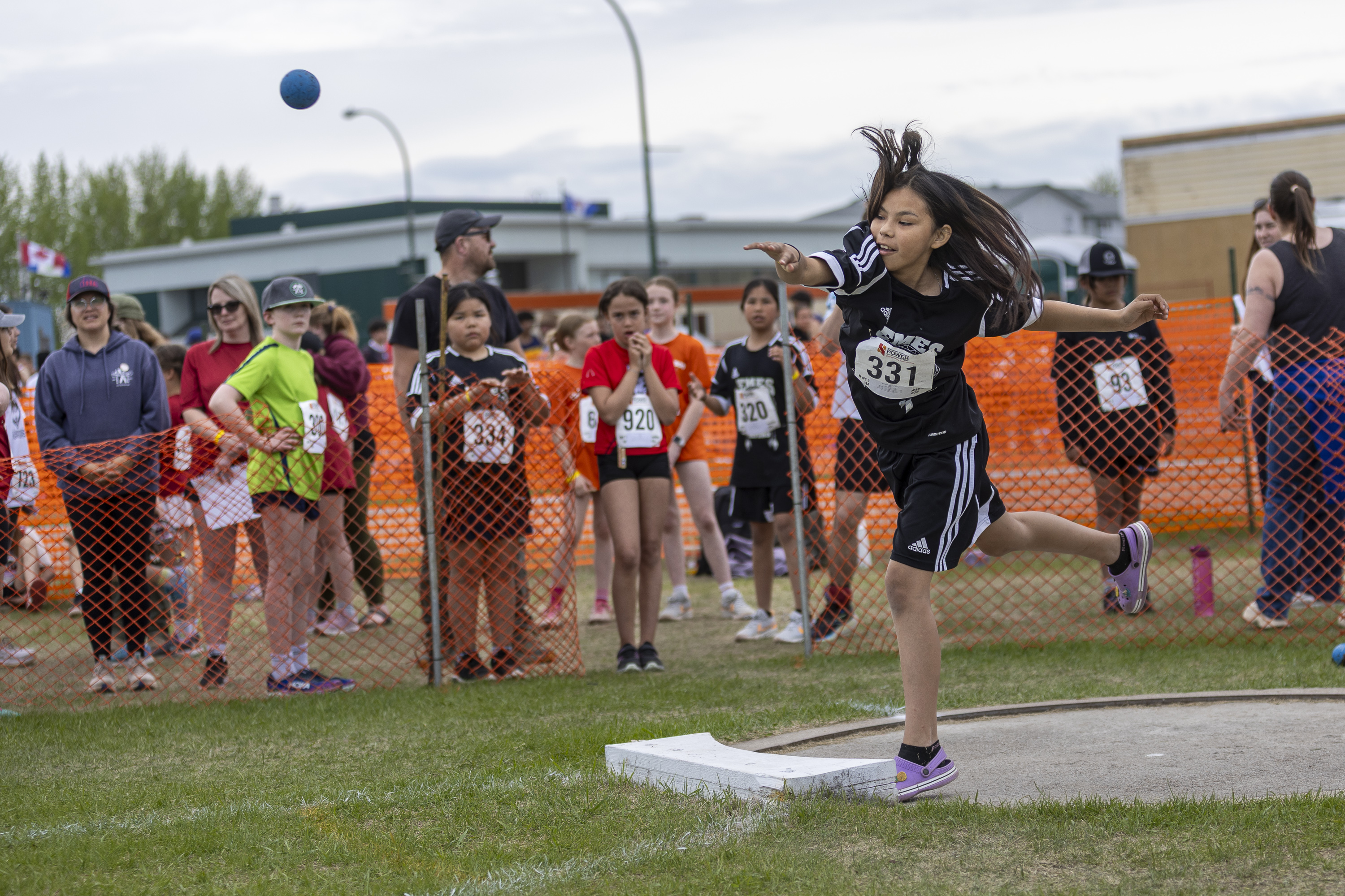 Sadie Wedzin throws for Behchokǫ̀'s Elizabeth Mackenzie Elementary School. Ollie Williams/Cabin Radio