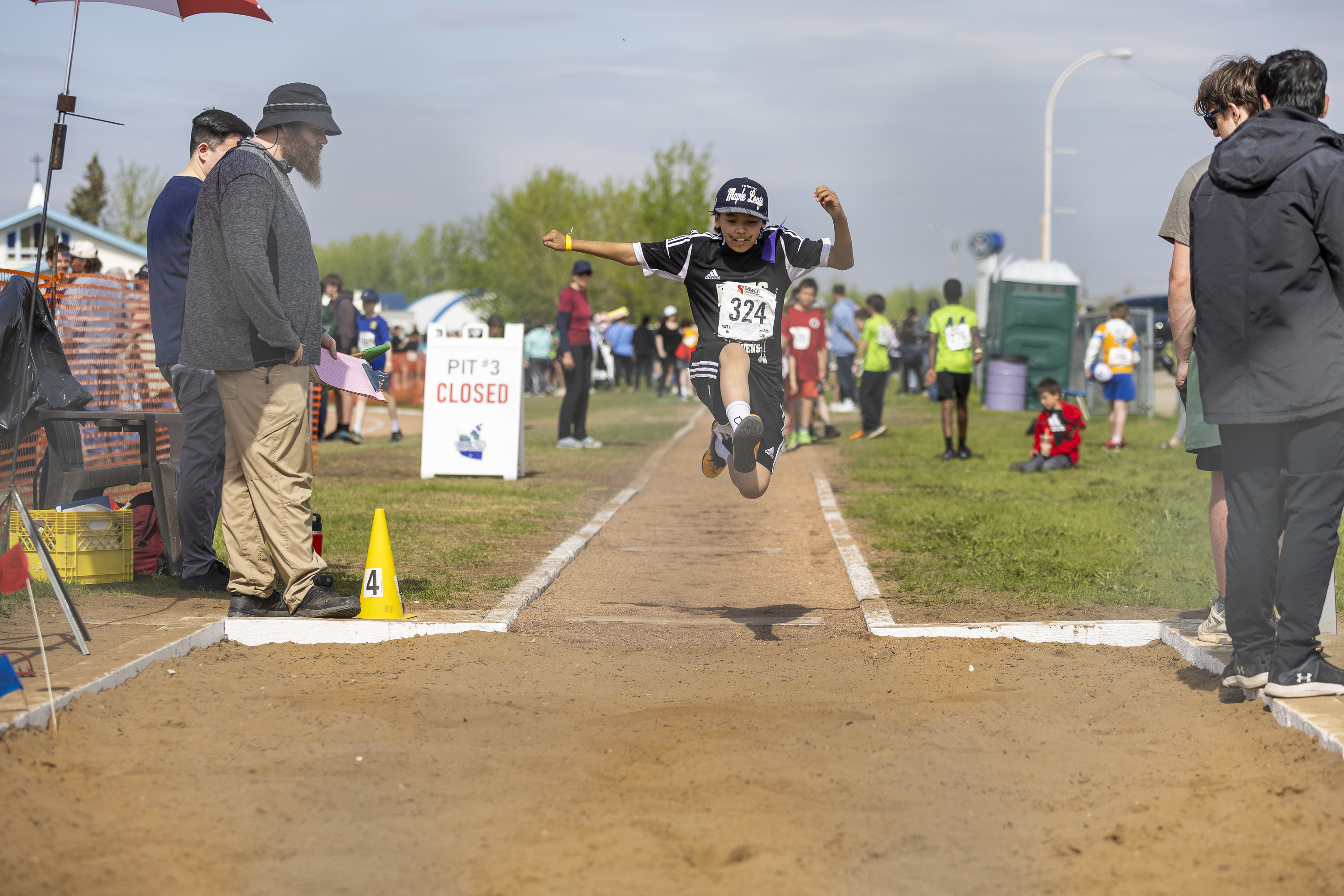 Mikey Lafferty is all smiles leaping into the long jump pit. Ollie Williams/Cabin Radio