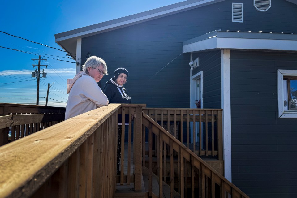 Housing minister Lucy Kuptana, left, on a tour of Inuvik's transitional housing facility. Ollie Williams/Cabin Radio
