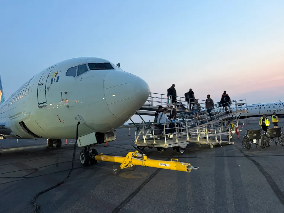 Evacuees from Fort Simpson arrive into Yellowknife on a Canadian North flight at 1:50am on Monday, June 29. Photo: Trung Bui