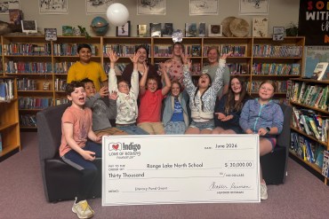 Students and staff at Range Lake North celebrate a $30,000 grant from Indigo Love of Reading Foundation. Jasmine Nasogaluak/Cabin Radio