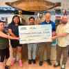 Representatives from the Northern Store present a cheque to the Hamlet of Fort Liard for upgrades to the baseball diamond. Photo: Submitted