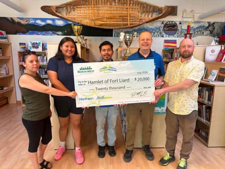 Representatives from the Northern Store present a cheque to the Hamlet of Fort Liard for upgrades to the baseball diamond. Photo: Submitted