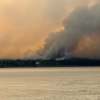 Bannockland, a Fort Simpson hotel, is seen with wildfire smoke behind it on July 3, 2026. Photo: Murray Sibbeston