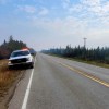 An RCMP image of a police truck on the highway outside Fort Simpson.