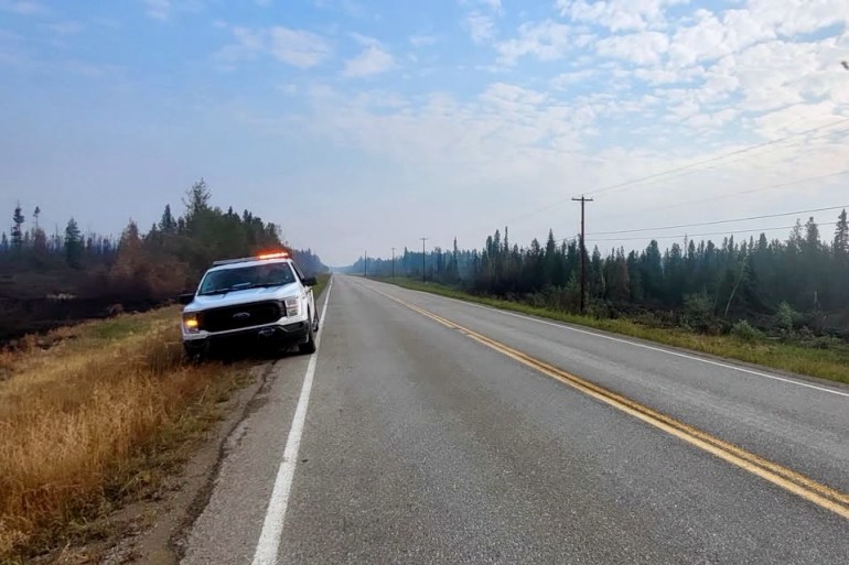 An RCMP image of a police truck on the highway outside Fort Simpson.