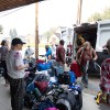 The village's operations manager, Mitch Gast, and others worked to unload evacuees' luggage that arrived on the return flights. Claire McFarlane/Cabin Radio