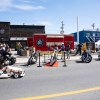 A child on an electric go-kart zooms around on 48 Street at the show and shine. Kai Wilson/Cabin Radio
