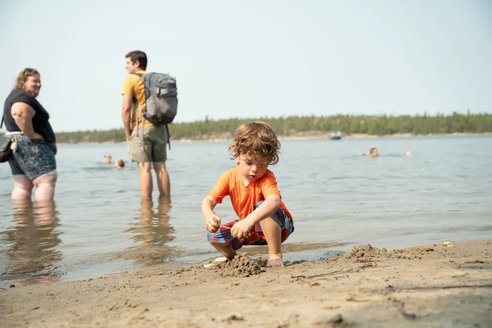 Cooling off at the lake during the first day at Folk on the Rocks 2026. Kai Wilson/Cabin Radio