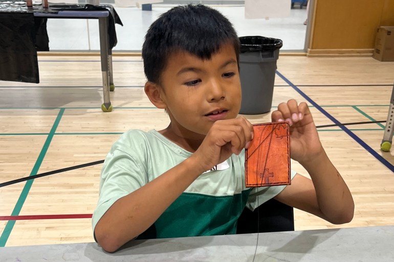 A young participant works on a wallet at a Fort Smith summer camp. Photo: Submitted