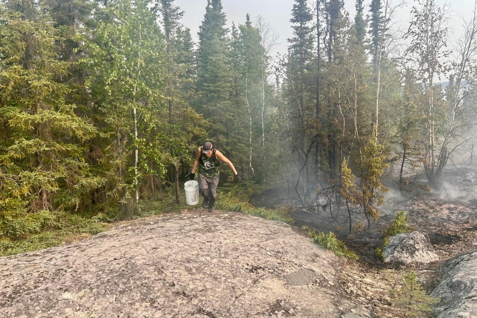Jayden Liske, a Ndılǫ resident, helps to tackle fire ZF027 on July 2, 2026. Photo: Submitted