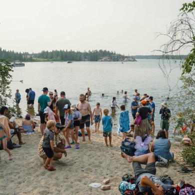 Festival attendees cool off at the lake at Folk on the Rocks 2026. Kai Wilson/Cabin Radio