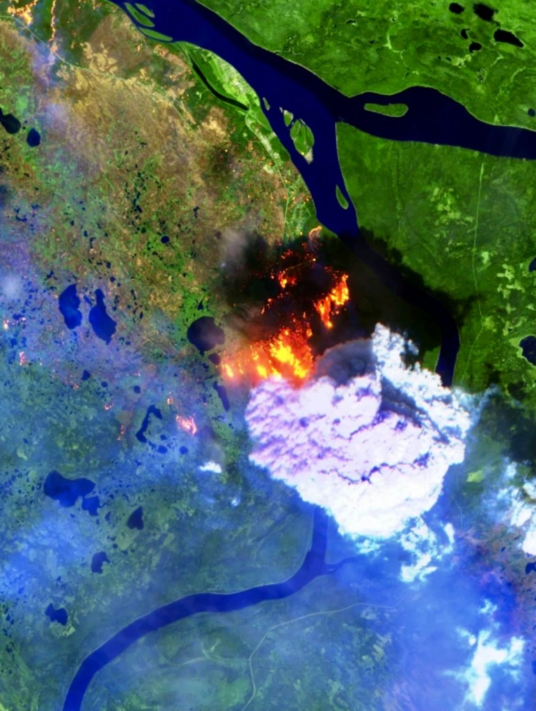A false-colour Sentinel-2 satellite image shows heat signatures and the smoke plume of fire FS016 as it is blown south of Fort Simpson on Saturday, July 4.