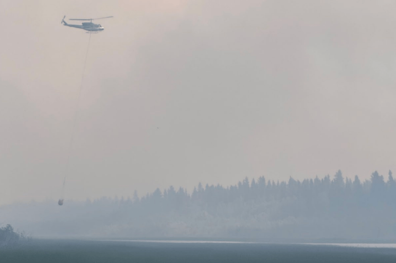 A helicopter bucketing fire FS016 on July 3, 2026. Photo: NWT Fire