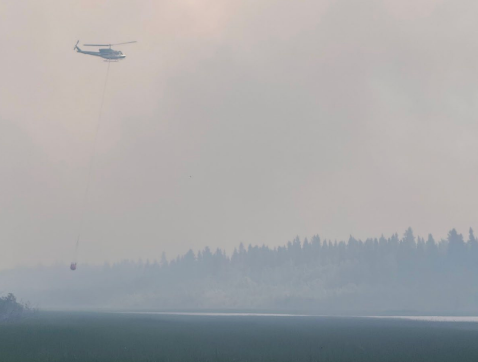 A helicopter bucketing fire FS016 on July 3, 2026. Photo: NWT Fire