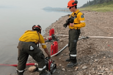 A crew outside Wrigley prepares pumps and hoses for a planned ignition. Photo: NWT Fire