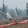 A high-volume suppression system installed near Wrigley, as depicted by NWT Fire in a series of images jointly credited to Connor Steed and Paul Klatt.
