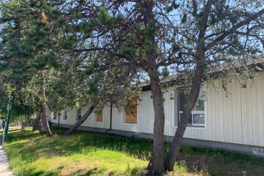 Boarded windows at Yellowknife's Mary Murphy seniors' home in July 2026. Photo: Alice Twa/Cabin Radio