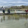 From left to right, Craig Scott, Nielz Huizenga and Kevin Bolstad clean up debris and fIx their docks. Photo: Cathie Bolstad