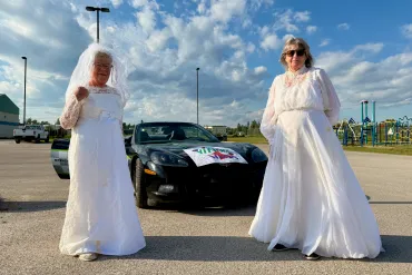 Marilyn Bennett, left, and Patti Haaima, the "vintage widows" of the 2026 Fort Smith Fireweed Festival. Ollie Williams/Cabin Radio
