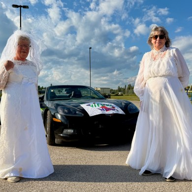 Marilyn Bennett, left, and Patti Haaima, the "vintage widows" of the 2026 Fort Smith Fireweed Festival. Ollie Williams/Cabin Radio