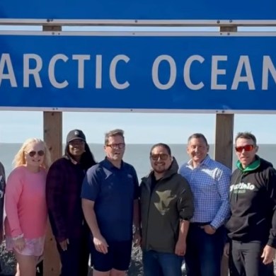 A still from a video published by Bob Zimmer shows David Epp, Lianne Rood, Leslyn Lewis, Zimmer, Billy Morin, Jamie Schmale and John Barlow in front of the Arctic Ocean sign during a recent visit to Tuktoyaktuk.