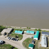 An image from GNWT contract documents shows an aerial view of Fort Good Hope's RCMP compound next to the Mackenzie River.