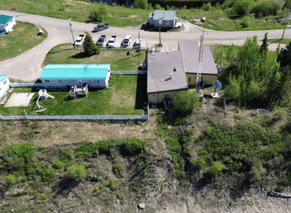 A GNWT drone image shows the riverbank behind Fort Good Hope's RCMP detachment.