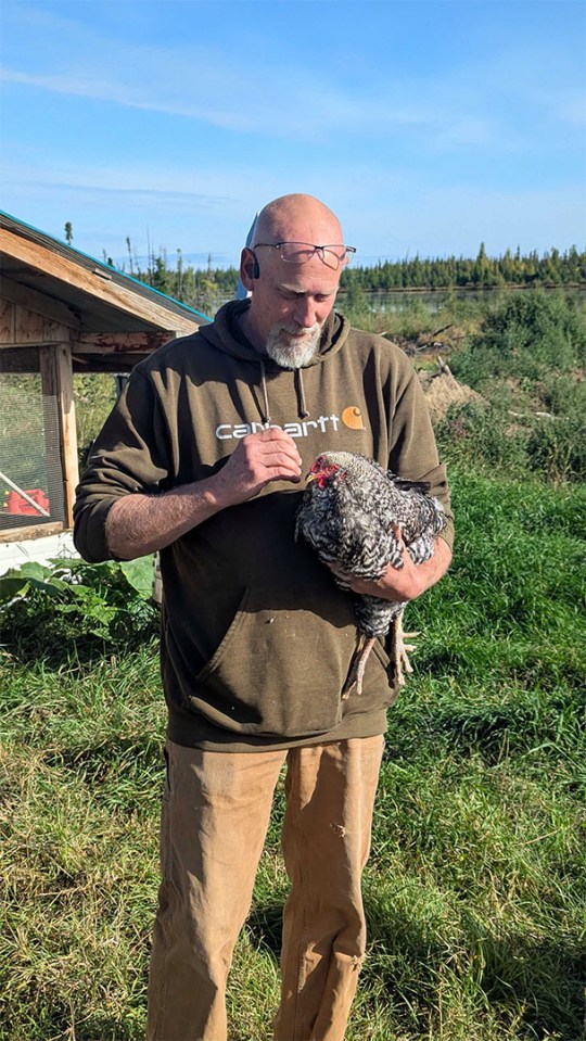 A man holds a chicken