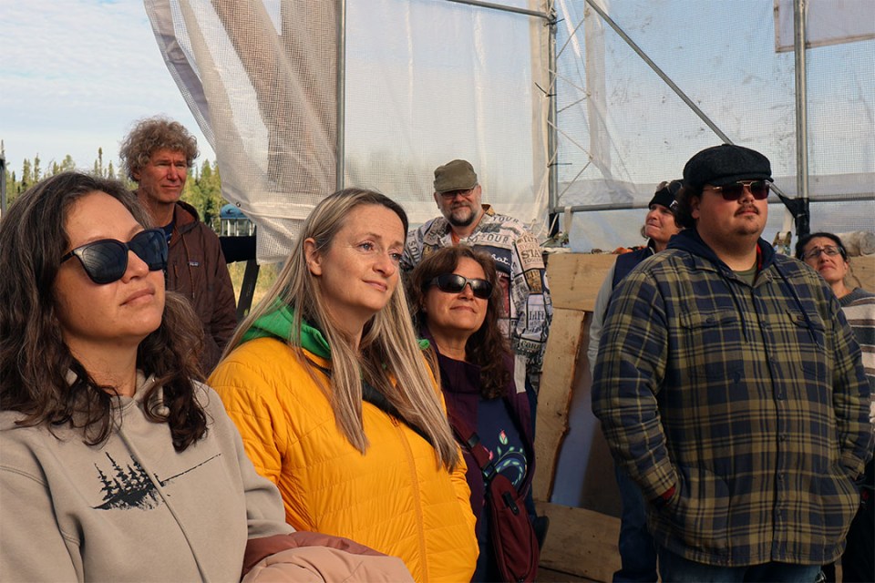 A group of people face a speaker